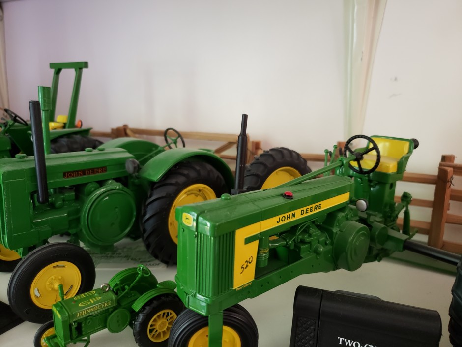 Miniature yellow and green John Deere tractor toys